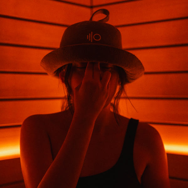 Breathwork in the red-lit sauna at ILO STUDIOS